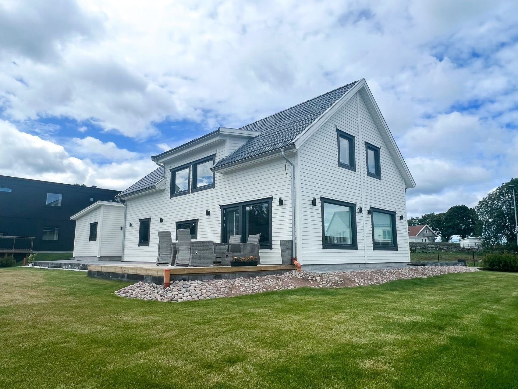 White two-storey villa with a terrace and lawn, Landvetter, enhanced